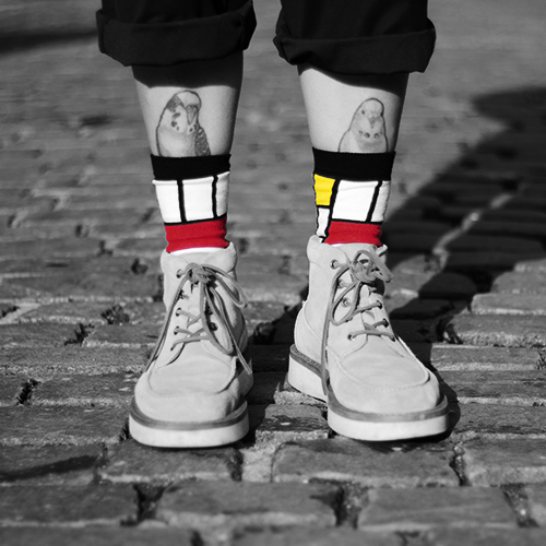 Schuhe mit Tattos und bunten Socken